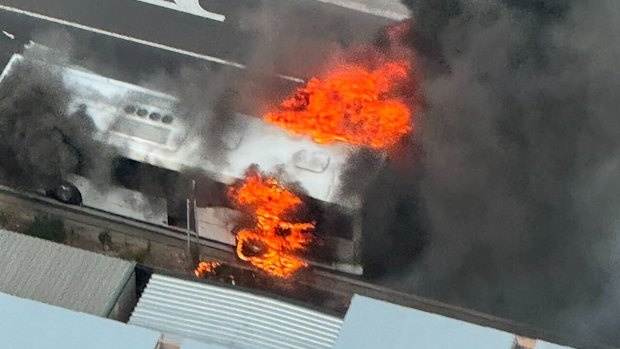 Fire rages from the back of the bus. 