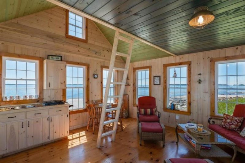 The home is a beautifully crafted wooden cabin.