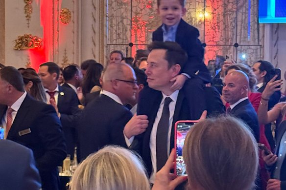 Elon Musk and his son, X Æ A-Xii, as the 2024 US presidential election results are broadcast at Mar-a-Lago in November.