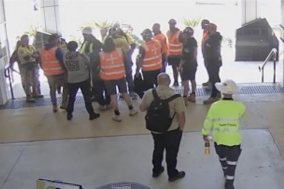 The CFMEU surround two AWU delegates at a Coles shopping centre  near the Woolloongabba Cross River Rail site.