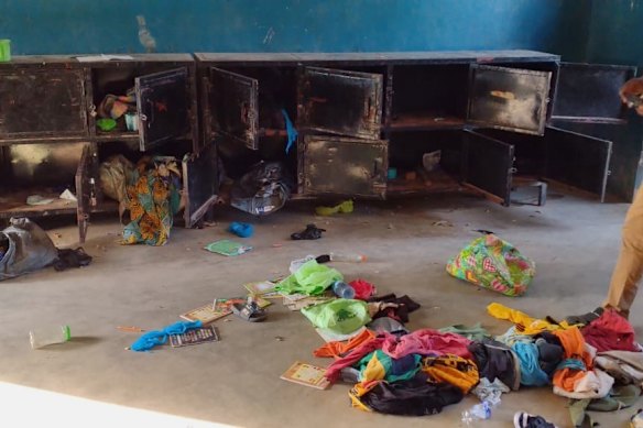 A man walks past belongings at the St Mary’s Catholic Primary and Secondary School in Papiri community, Nigeria, after gunmen abducted children and staff. 