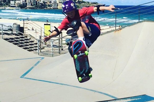 Ethan Strange showing of his skateboarding skills at Bondi Beach
