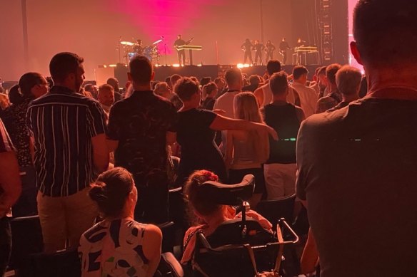 A wheelchair user struggles to see the stage and screens at the Kylie Minogue concert at Brisbane Entertainment Centre.
