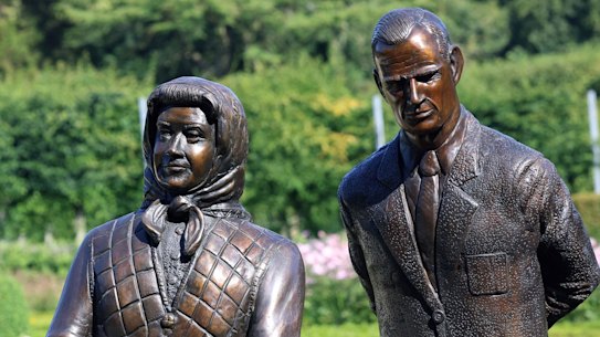 The sculpture of Queen Elizabeth II - clad in a headscarf, tartan skirt and quilted vest - standing next to the previously erected statue of her husband, Prince Philip in Parterre Garden.