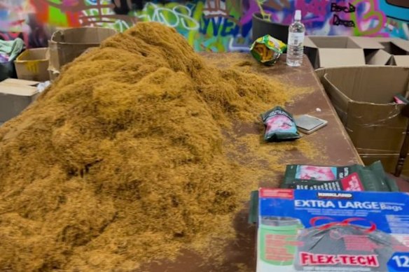 Huge quantities of tobacco were found on a table, with stacks of counterfeit Australian packaging nearby.