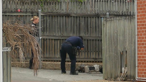 Police take photos of an electric scooter at the scene in Water Street.