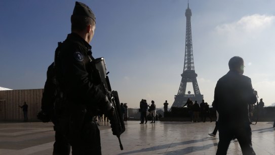 French police officers patrol near the Eiffel Tower after the Paris attacks.