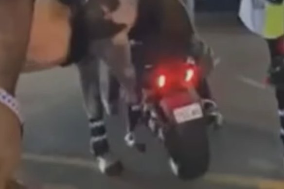 A motorcyclist has been charged after two police horses were injured during an incident at the Gold Coast.