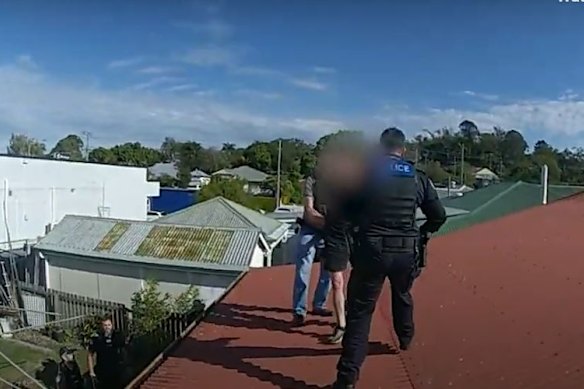 A man has been arrested after allegedly driving away from police in a stolen car and then climbing onto a roof.