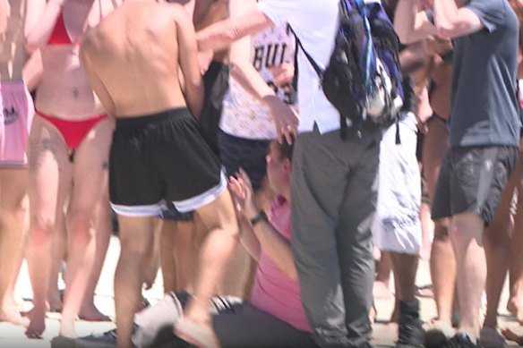 The man surrounded by his alleged attackers at St Kilda pier.