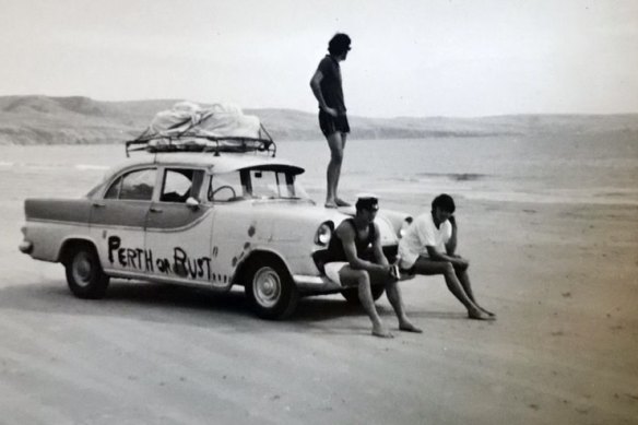 Carlo Massola (standing on the bonnet) and friends driving across the Nullarbor in 1971.