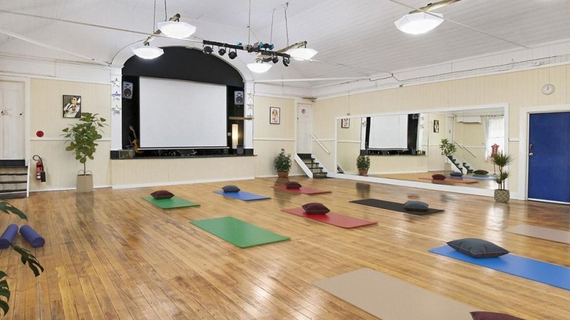 The three-bedroom home comes with a former dance hall, staged here as a yoga studio.