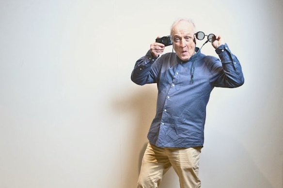 Cornea recipient Ralph Kerle with a camera and the spectacles he uses to supplement his eyesight.