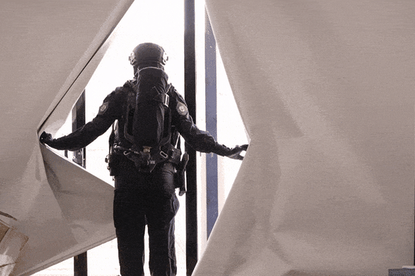 Armed police wearing ventilation masks raid properties allegedly used as safe houses.