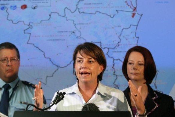 Then premier Anna Bligh, flanked by then Deputy Police Commissioner Ian Stewart and Prime Minister Julia Gillard, urges Queenslanders to remain strong during the 2011 floods.