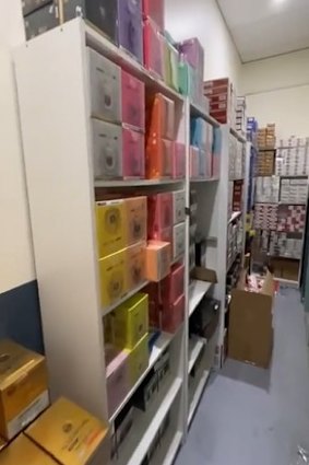 A cabinet concealing a secret storeroom filled with more than 5000 illegally imported cigarette packets.