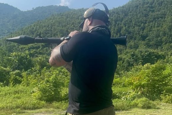 Daniel Jones, who runs a self-defence outfit, has posted pictures and videos of himself wielding guns and even rocket launchers online.