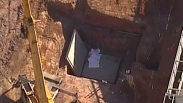 The pit in which the men were working when they were crushed by a falling slab.