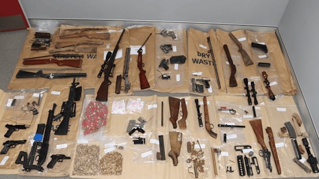 The cache of guns and weapons found in the squalid home.