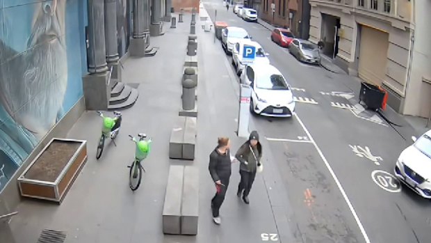 CCTV footage showing the moment a woman (left) allegedly stabbed Wan Lai in Melbourne’s CBD on October 2.