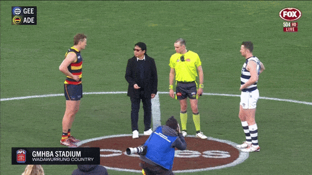 Sy Giang Nguyen tosses the coin before a Geelong-Adelaide AFL game in August 2024.