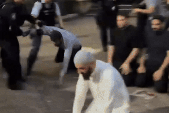 Police faced backlash after Muslims bowed in prayer were forcibly moved on after the Town Hall rally.