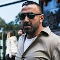 A former bikie boss has been detained in Bali after he was allegedly found hiding in the toilet of a private jet bound for Africa.