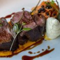 Lamb rump on a bed of carrot puree.