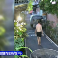A Queensland man has been arrested in Bali over a daylight rendezvous with a mystery woman in a driveway.