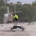 Astonishing vision has captured the moment a dog was rescued from a car trapped in floodwaters in Katherine.