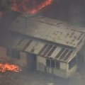 Buildings have been destroyed in the Perth Hills as a raging bushfire blocks evacuation routes.