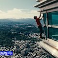 American rock climber Alex Honnold reaches the top of 508-metre skyscraper without ropes.