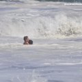 US President Donald Trump has praised a 16-year-old lifeguard who went viral after rescuing a young boy from enormous waves in Santa Cruz, California.