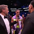 Jai Opetaia stands inside the ring and challenges David Benavidez to a fight in 12 months time.