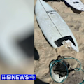 A father is in hospital with a serious leg injury after he was attacked by a shark in Western Australia.