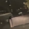 A Canberra driver has captured two couch-riders appearing to power a couch using e-scooters down a dark street in the rain.
