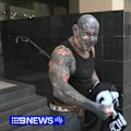 Perth bikie Dayne Brajkovich has faced a Perth court after inadvertently exposing a belt bearing alleged gang insignia while giving a homeless man his jumper.