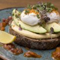 Avocado and hummus on rye with poached eggs, honey-candied bacon and dukkah at The Jetty Oxford.