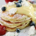 Sweet start: Fluffy hotcakes with passionfruit curd and fruit.