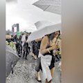 Umbrellas were turned inside out and groups hunkered down to hide from the wild weather and strong gusts of wind.
Some even found cover in Flemington's famous rosebushes.