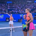 Aryna Sabalenka and Elina Svitolina take separate photos after the coin toss.