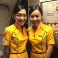 Nok Air's all-female crew wear sunny yellow uniforms.