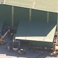 A horrific workplace accident has left a man critically injured south-east of Brisbane.