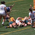 Emily Chancellor helps drive Eva Karpani over as the Wallaroos thrash Scotland in Sydney on Saturday.