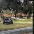 A police officer has jumped out of the path of a car, which was allegedly stolen and leading police on a high-speed pursuit.
