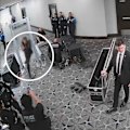 The annotated footage shows the suspect sprinting through a checkpoint and raising a gun.