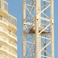 Police are negotiating with a man who climbed halfway up a construction crane in Miami on the Gold Coast.