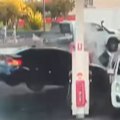 Video shows a black sedan barely missing a pedestrian and smashing into a bowser as it tries to turn into a Sydney petrol station.