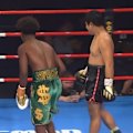 Referee Phillip Holiday takes a tumble in the Suliaman Guushaa and Uten Chanavon fight.