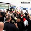 Iraqis in Australia have welcomed Graham Arnold home at Sydney Airport after he led an epic qualifying campaign to get the national football team to the World Cup.